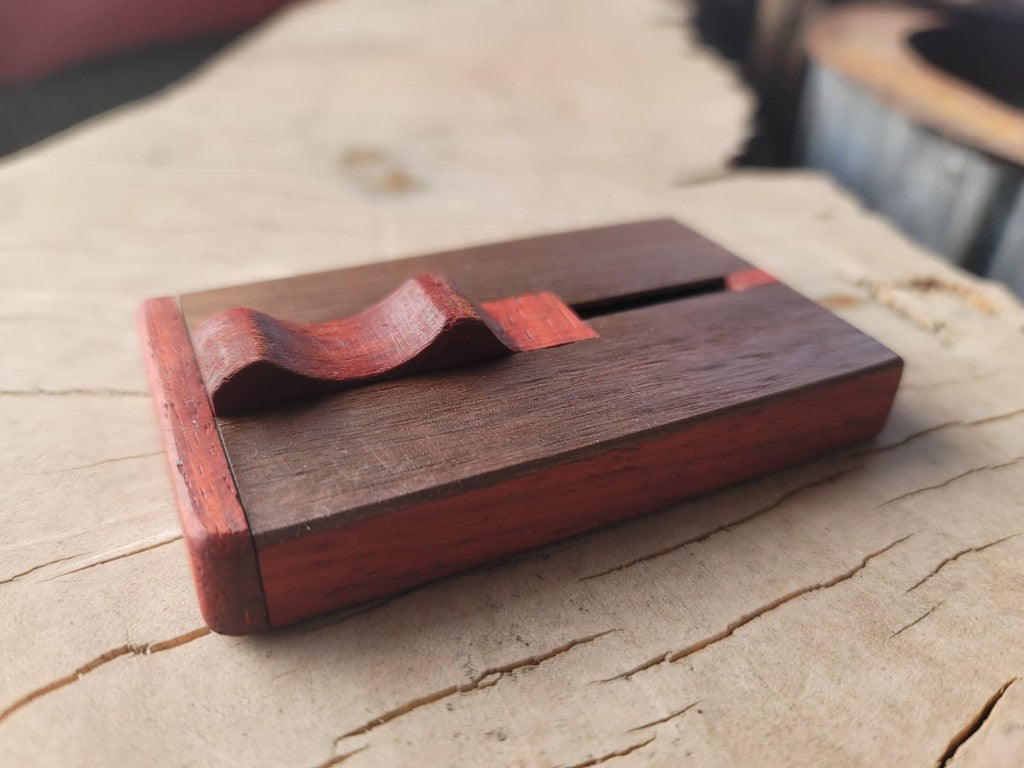 Closed North 44 wallet at a three-quarter angle on a cross-cut wood surface